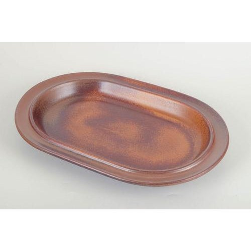 Ulla Procopé for Arabia Finland Oval stoneware serving dish, 1970s. Softly rounded oval form coated in the warm brown...