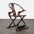 This unique chair features a traditional Chinese horseshoe-shaped back and elegant red and gold detailing. The wooden...