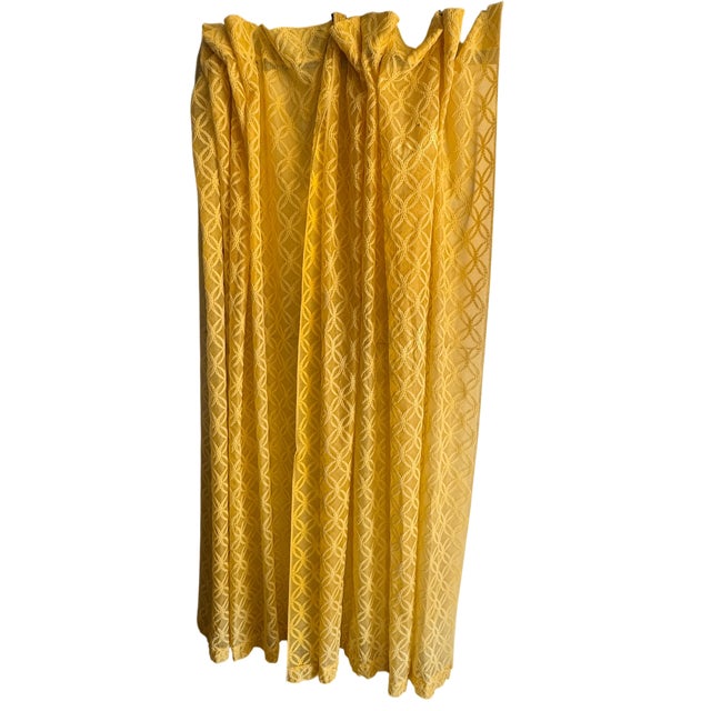 Sheer yellow curtain. One small spot can most likely be removed. This damage is photographed.