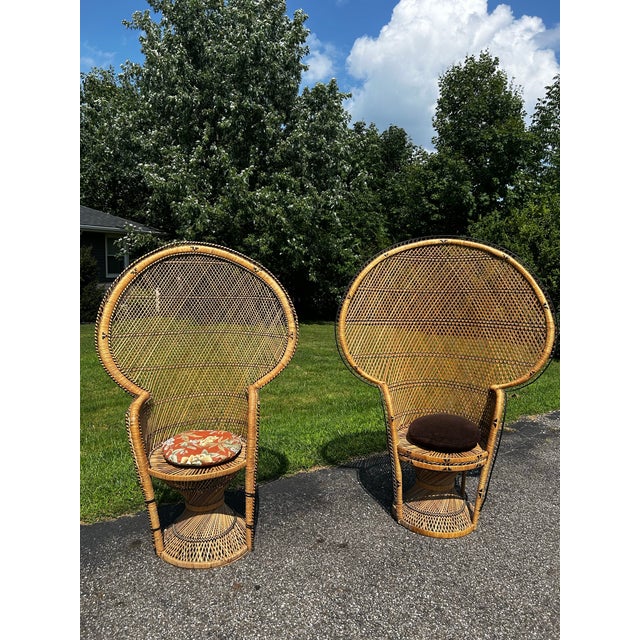 This pair of vintage 1970s boho wicker and rattan peacock chairs features high, dramatic fan backs and hourglass pedestal...
