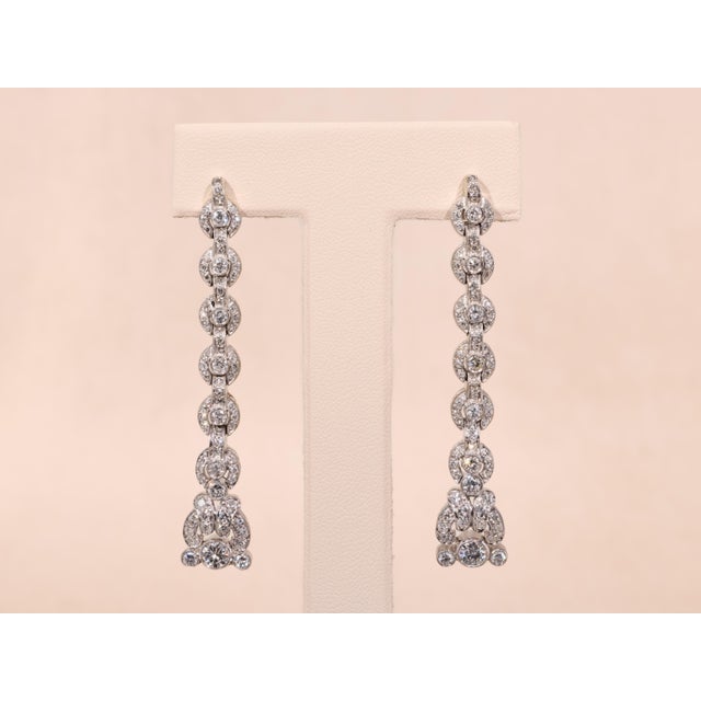 The Santa Rosa Outstanding Antique Platinum Dangler Earrings. The earrings feature a large old European cut center diamond...