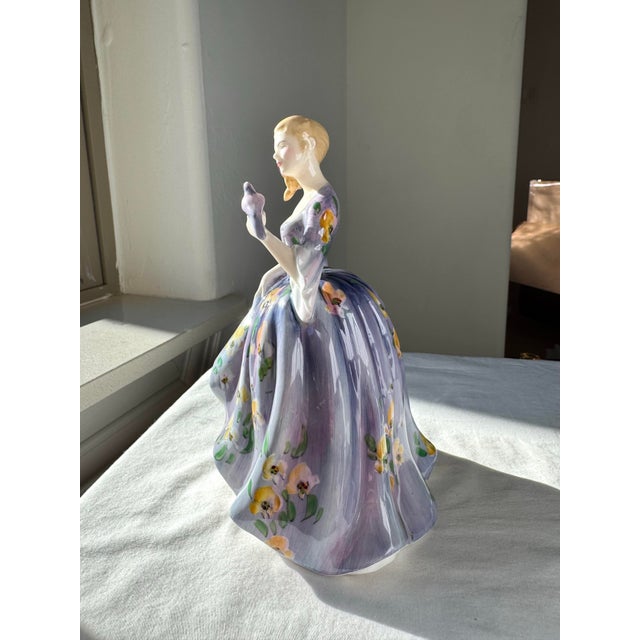 “Nicola” (H.N. 2839), introduced by Royal Doulton in 1967, is a finely modeled bone china figurine from the H.N. series....