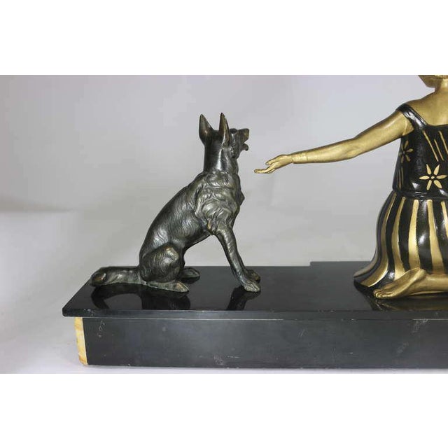Beautiful Art Deco black and gold patinated bronze sculpture of a beautiful seated lady with two, German shepherds,...