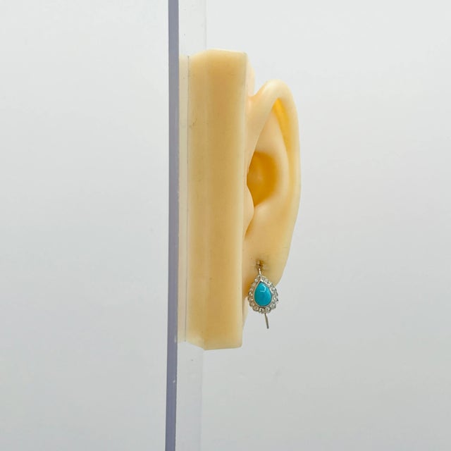 Beautiful turquoise pear shapes with good quality white diamond rounds. Handmade in 18k white gold.