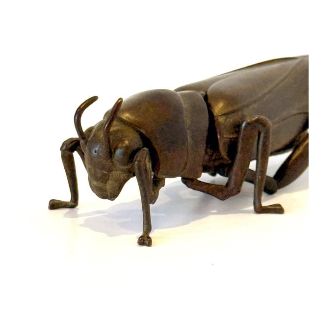 A bronze Japanese okimono cast in refined and realistic form of a grasshopper attributed to Myochin lineage circa 19th...