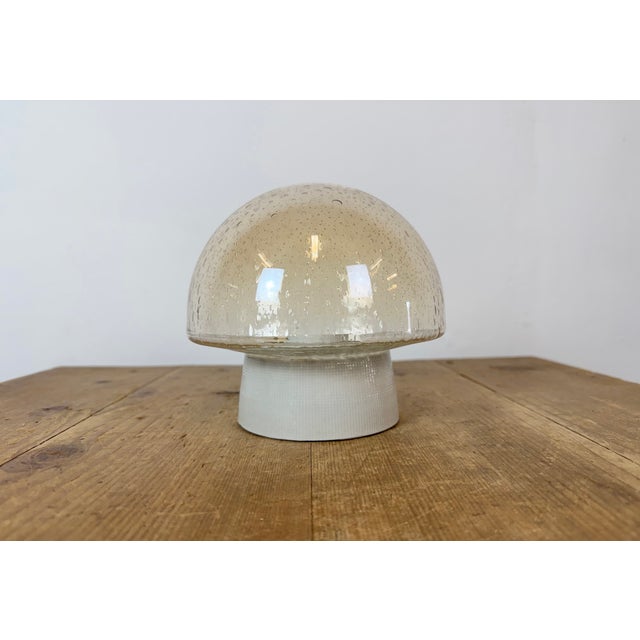 Vintage industrial ceiling or wall light made in former Czechoslivakia during the 1970s. It features a white porcelain...