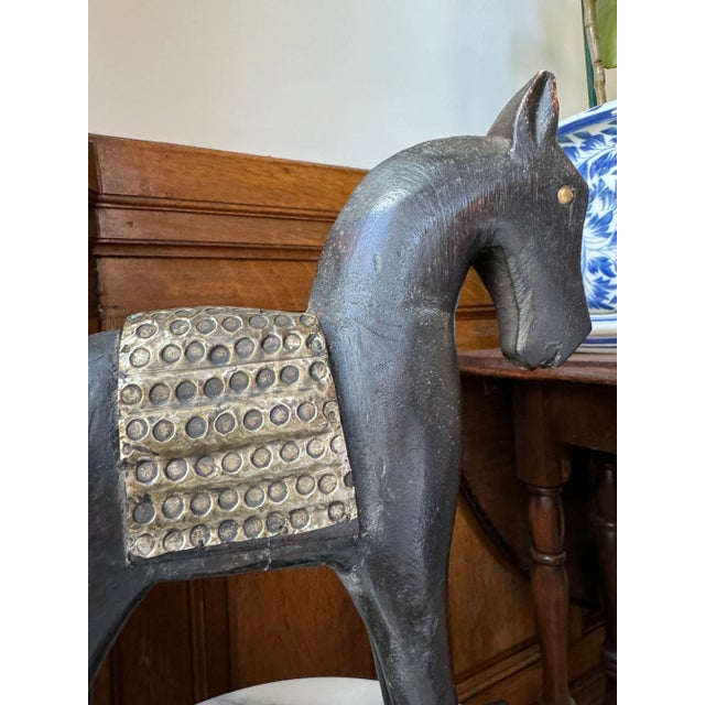 Hand carved horse figure with hammered metal armor and eyes. Very dark brown stain. Stands on an attached base. Perfect as...