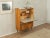 A wonderful bureau from the 1950s. Its walnut veneer body features a hinged work surface covered in cream-white Formica,...