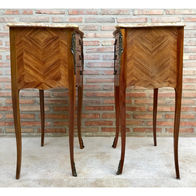Pair of bedside tables or side tables or nightstands in French walnut with marquetry and marble top from the mid-20th...