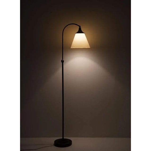 Lovely Art Deco floor lamp, manufactured in Sweden, 1920s. The lamp consists of a base and rod in bronze, supporting a...