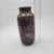 This hand-thrown ceramic vase showcases Jean Mann's artistry with a captivating multicolor glaze. A vintage collectible,...