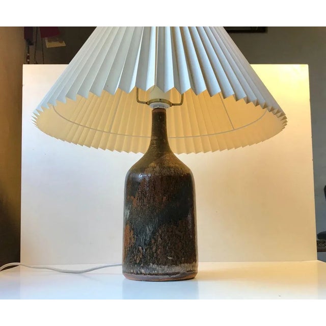 Monumental stoneware table lights with earthy iron-like polychrome glazes. Designed by danish ceramist Conny Walther...