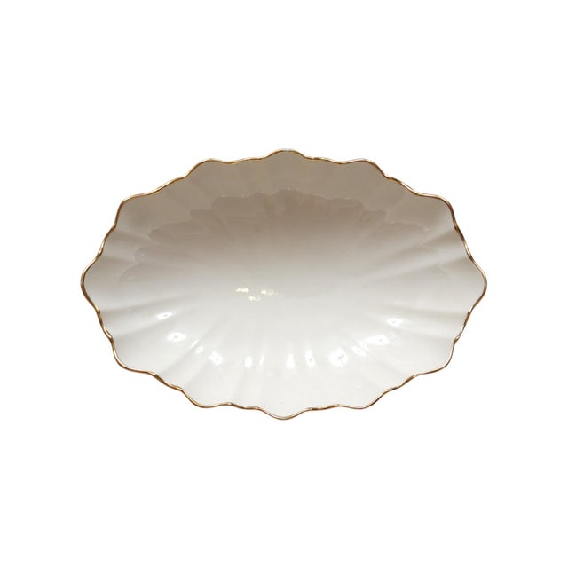 A ceramic scalloped dish by Lenox, made for their Symphony collection circa 2000. The undulating fluted shape is decorated...