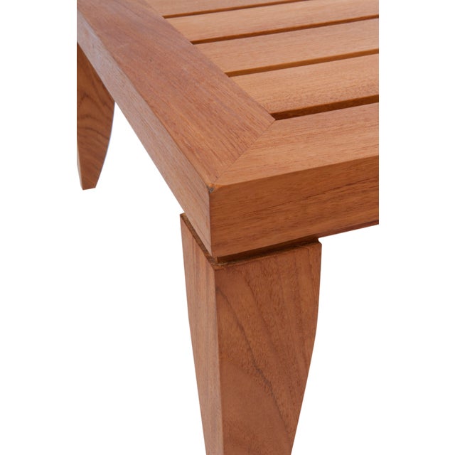 A solid teak wood cocktail table by Donghia features a slat style top and sabre shaped legs. Perfect as a low coffee table...