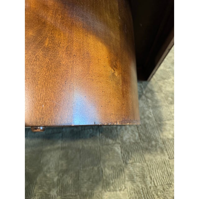 A burl wood coffee table in the style of Milo Baughman, circa 1970s. Showcasing rich patterns and a bold, sculptural...