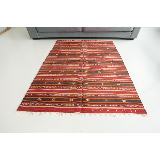 This is a vintage Turkish Oushak rug from the Mid 20th Century. The piece was hand-knotted.