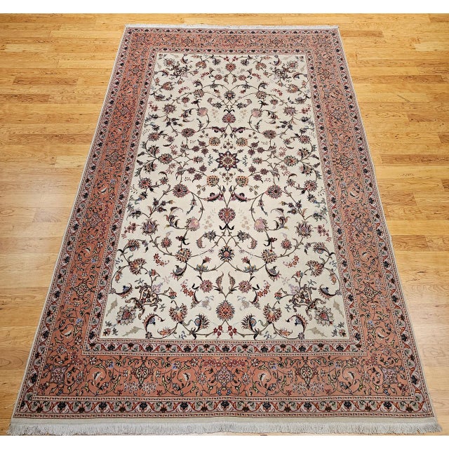 "This vintage Persian Tabriz rug presents a rare and sought-after allover floral pattern, woven with masterful precision...