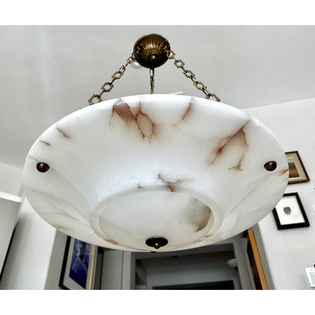 An elegant Directoire-style French pendant chandelier crafted from beautifully carved natural alabaster stone. The fixture...