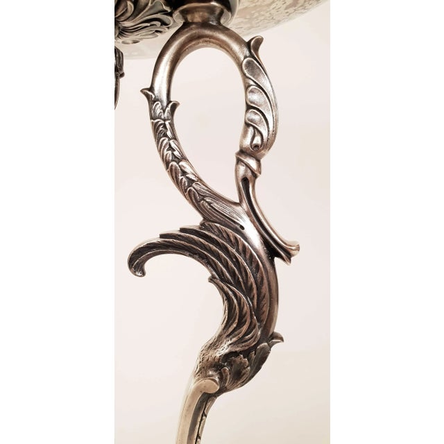 Important centerpiece in the Empire Restoration style, in silver plated metal with a large openwork gallery cup with...