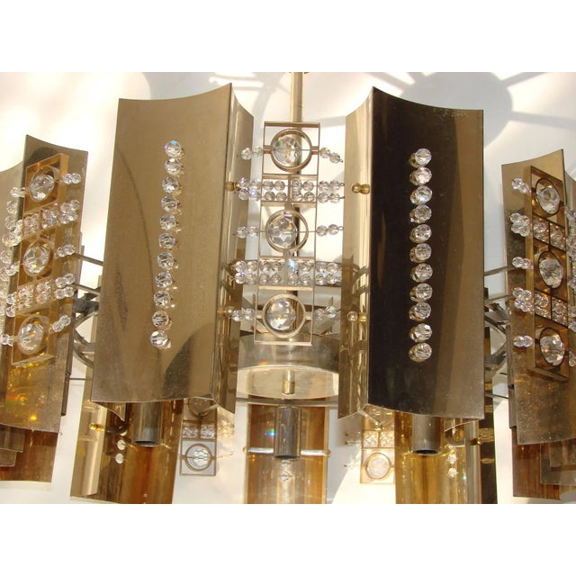 - Chandelier in the style of Gaetano Sciolari, 1970s - Made of brass, the middle part is nickel-plated - Shiny crystal...