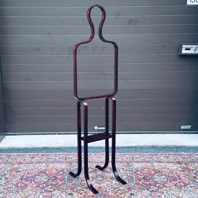 Vintage figurative bentwood valet in the style of Alvar Aalto unmarked in laminated beech with rosewood finish and catch-...