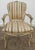 This Vintage Arm Chair has a Venetian Style . The Frame is Wood. The Color is Cream with a Distressed Finish. Stripe...