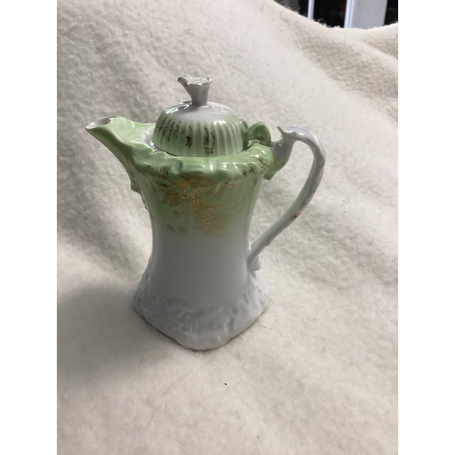 This beautiful creamer is a rare find in this condition and this color. It has a pale green color with gold accents,...