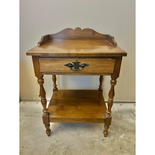 Bring a touch of classic American craftsmanship into your space with this handsome vintage side table. Solid wood...