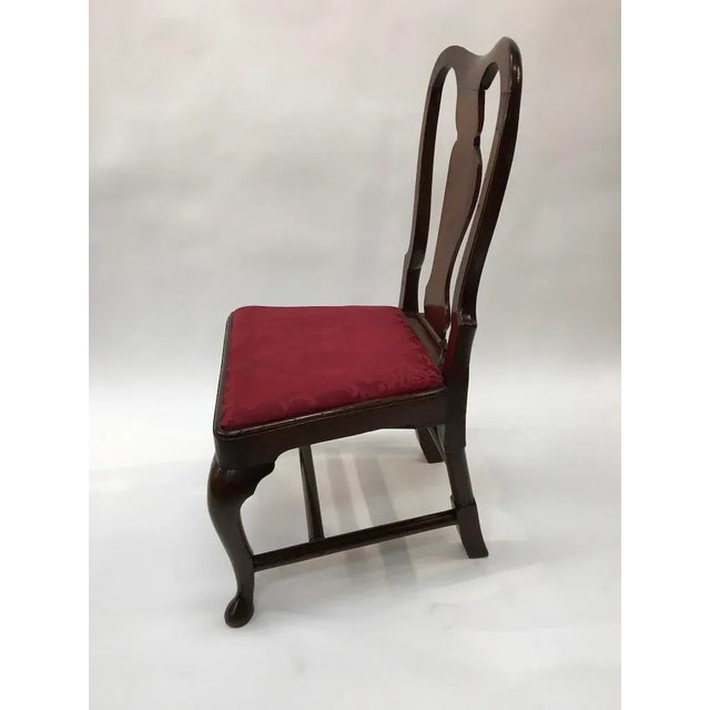 An early American walnut side chair with crunch figured back splat, drop in seat on cabriolet legs ending in a slipper foot