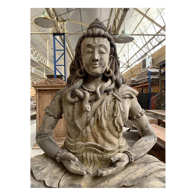 This large wooden sculpture of Shiva, whose posture and attributes are reminiscent of a Buddha, is an impressive work of...