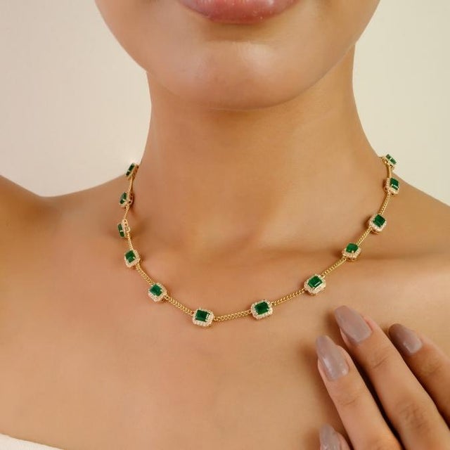 This elegant station necklace showcases 14 octagon-cut emeralds 6.2 cts and round brilliant diamonds 1.35 cts, set in 14K...