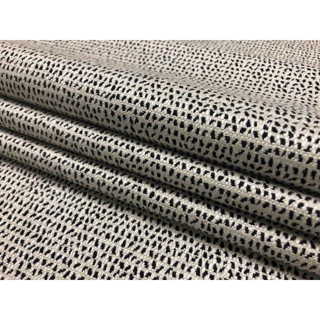 55" wide designer small scale abstract animal pattern upholstery & drapery fabric in cream and black. Price is per yard.