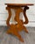 This is a signed studio-crafted Arts & Crafts style round side table with a sculptural lyre or harp form base, spindle...