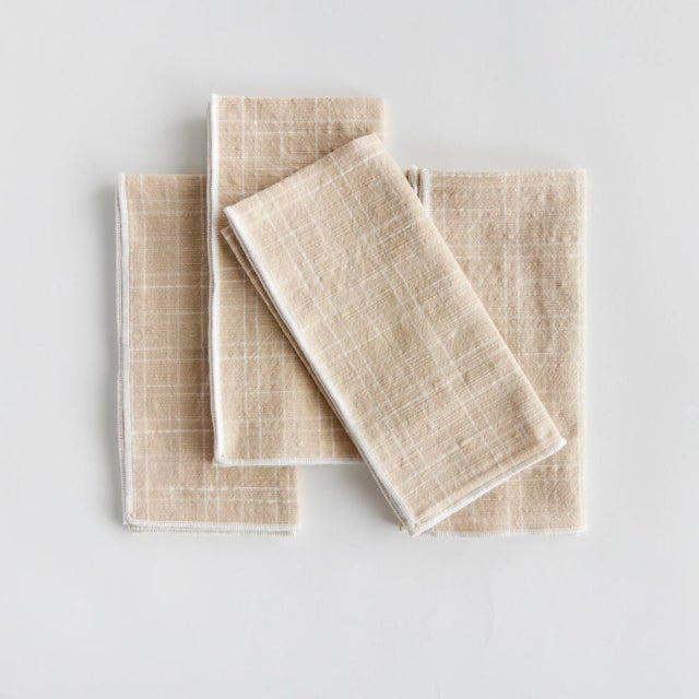 Bring a touch of softness to the table with this set of four cotton napkins. Beautiful in tone and texture, the soft taupe...