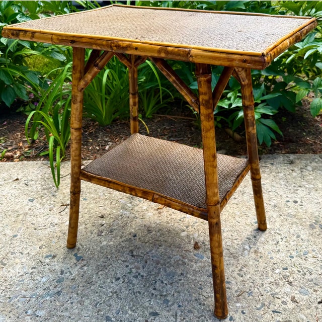 Late 19th century English tiered table with torched bamboo base and rattan top.