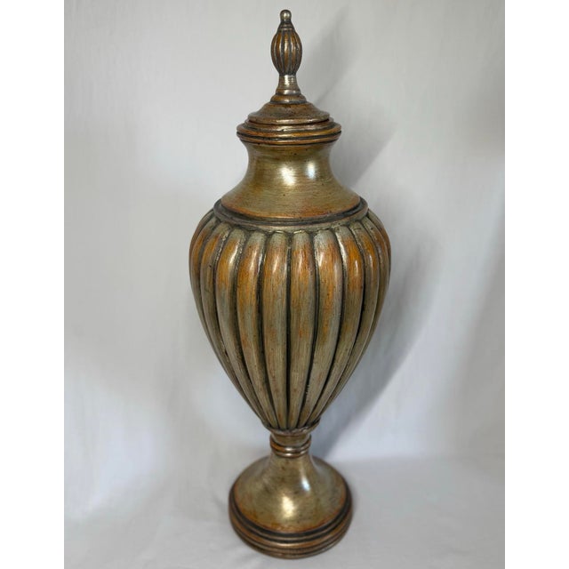 Uttermost 23” tall lidded jar urn. Patinated finish with gold, silver, amber, and russet brushstrokes that meld visually...