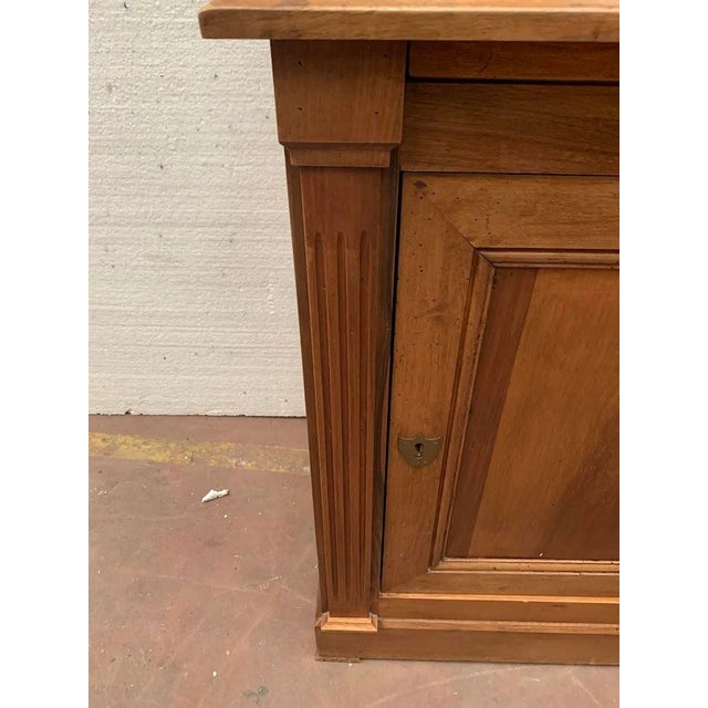 Directoire-style two-part, single-door display cabinet Made of solid walnut Glazed upper section Good overall condition...