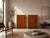 An elegant pair of tall Italian sideboards, made around 1980, characterized by their architectural proportions, the visual...
