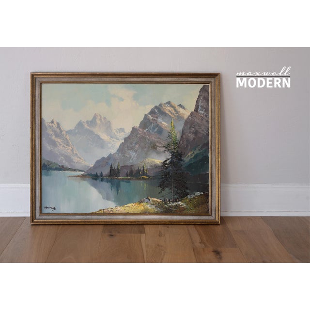 Vintage signed landscape painting featuring a picturesque nature scene with snow-capped mountains and a lake. The...