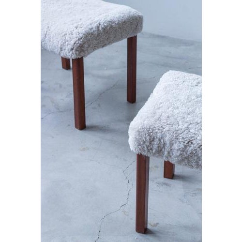 Pair of Danish modern stools designed and made in Denmark during the 1940s. Powerful square legs with slight rounding in...