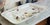 A very large rectangular platter with scalloped edges, made of fine cream-glazed earthenware, decorated with a painted...
