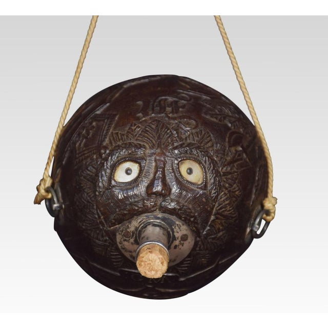 19th Century carved Bug Bear coconut flask, having relief carved all over with portrait of a sailor and Naval crest with...