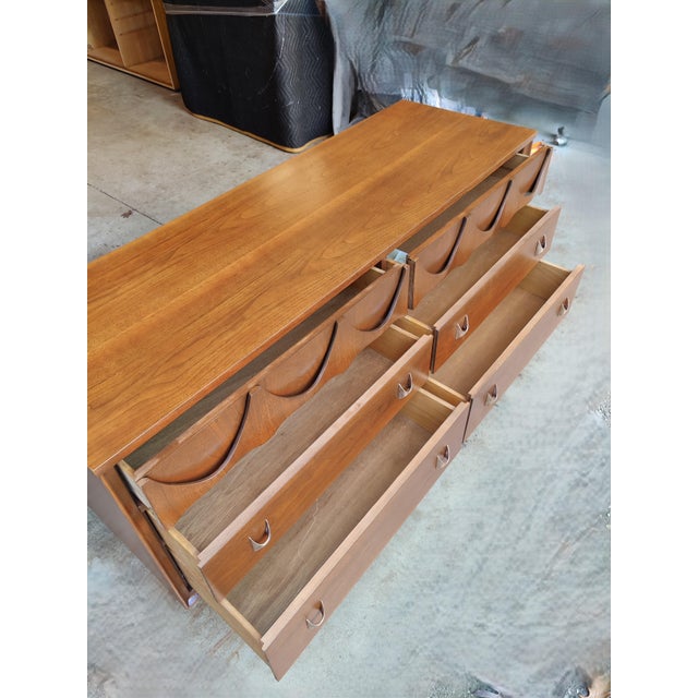 A beautiful Broyhill Brasilia lowboy dresser. It includes the original mirror, rarely seen for sale. The Brasilia line of...