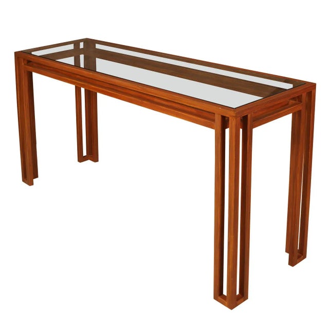 A Billy Baldwin style glass top console table with open grid design and faux bois painted metal frame. This modern console...