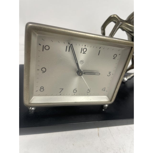 Beautiful 1920s Liberty Clock, with shiny black glass base and Roman metal sculpture. Excellent furnishing object.