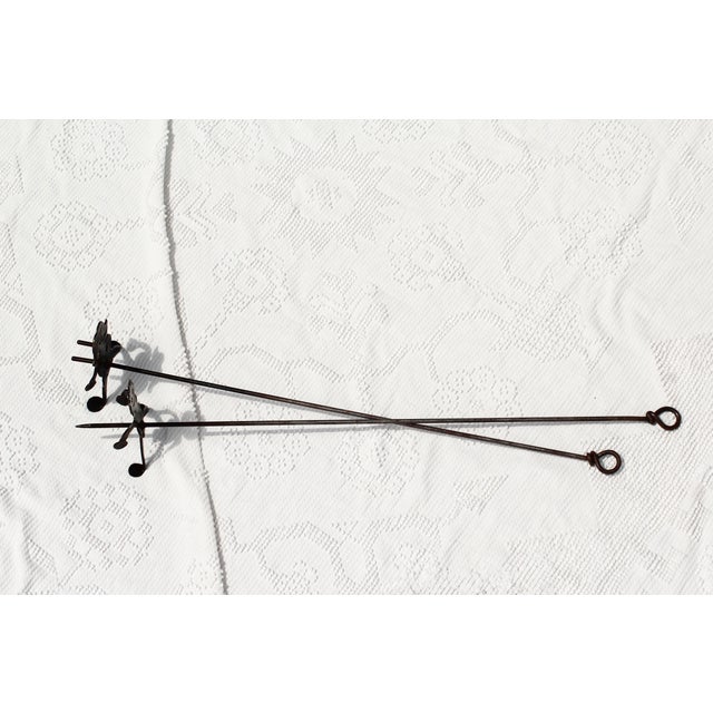 A little bit naughty black wrought iron campfire skewers in a man and a woman design. Black iron with the pokers being the...