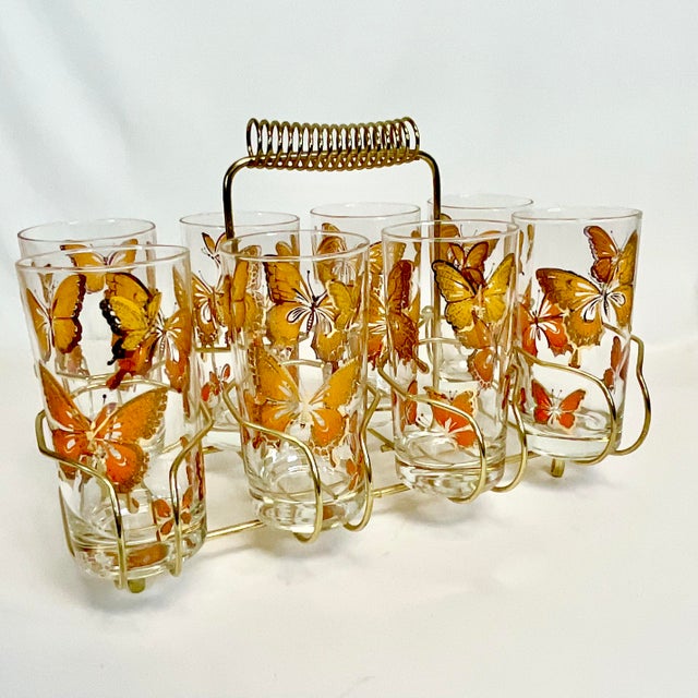 We love the Mid-Century Atomic style which is exactly the style of this glass set with caddy which has a Brass finish...