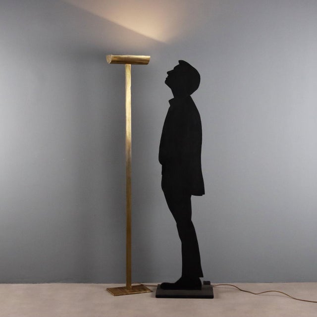 Floor lamp made of brass, features a halogen light. This piece is attributed to the mentioned designer/maker. It has no...