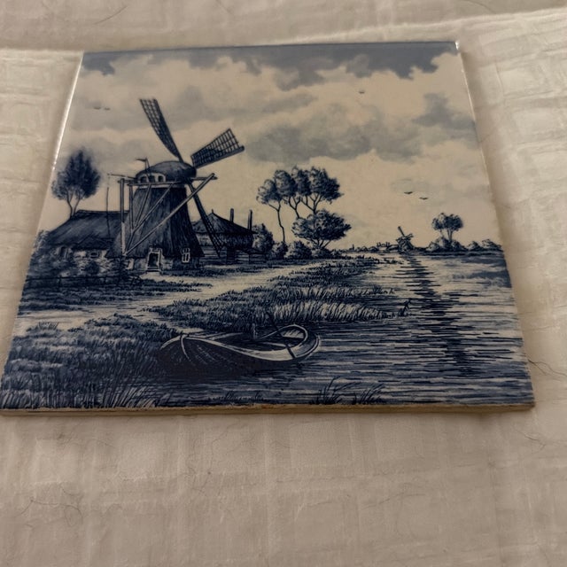Vintage Delft plate depicting Holland scenery. Windmill, small row boat and a picturesque canal are shown in this soothing...