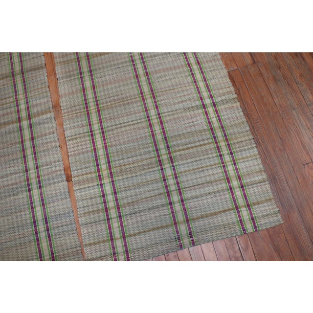 A rare matching set of rag rug runners containing a plaid motif on a straw colored ground from the mid-20th century...
